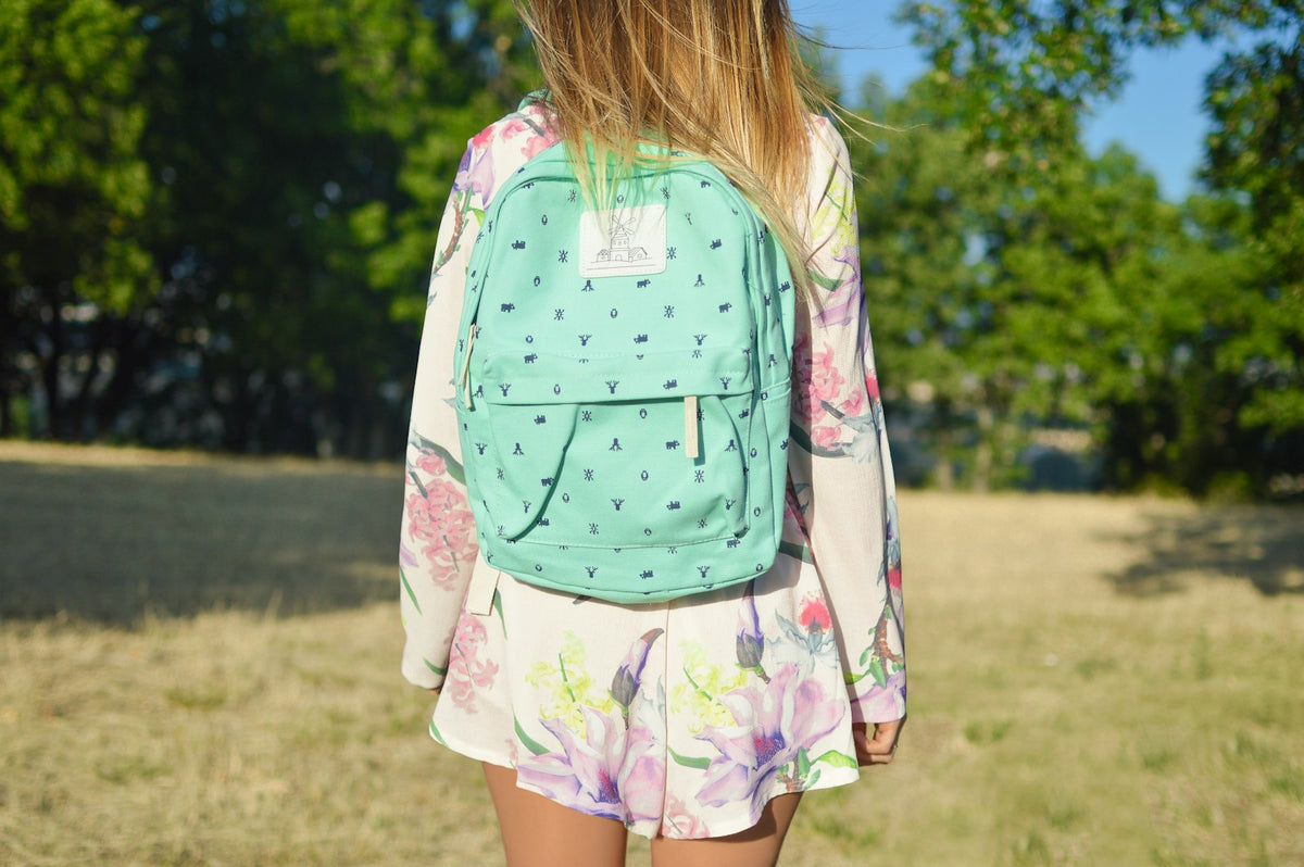 Person wearing a green backpack outdoors