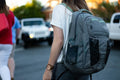 Person wearing a grey backpack