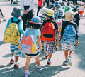 Group of people walking while wearing packs