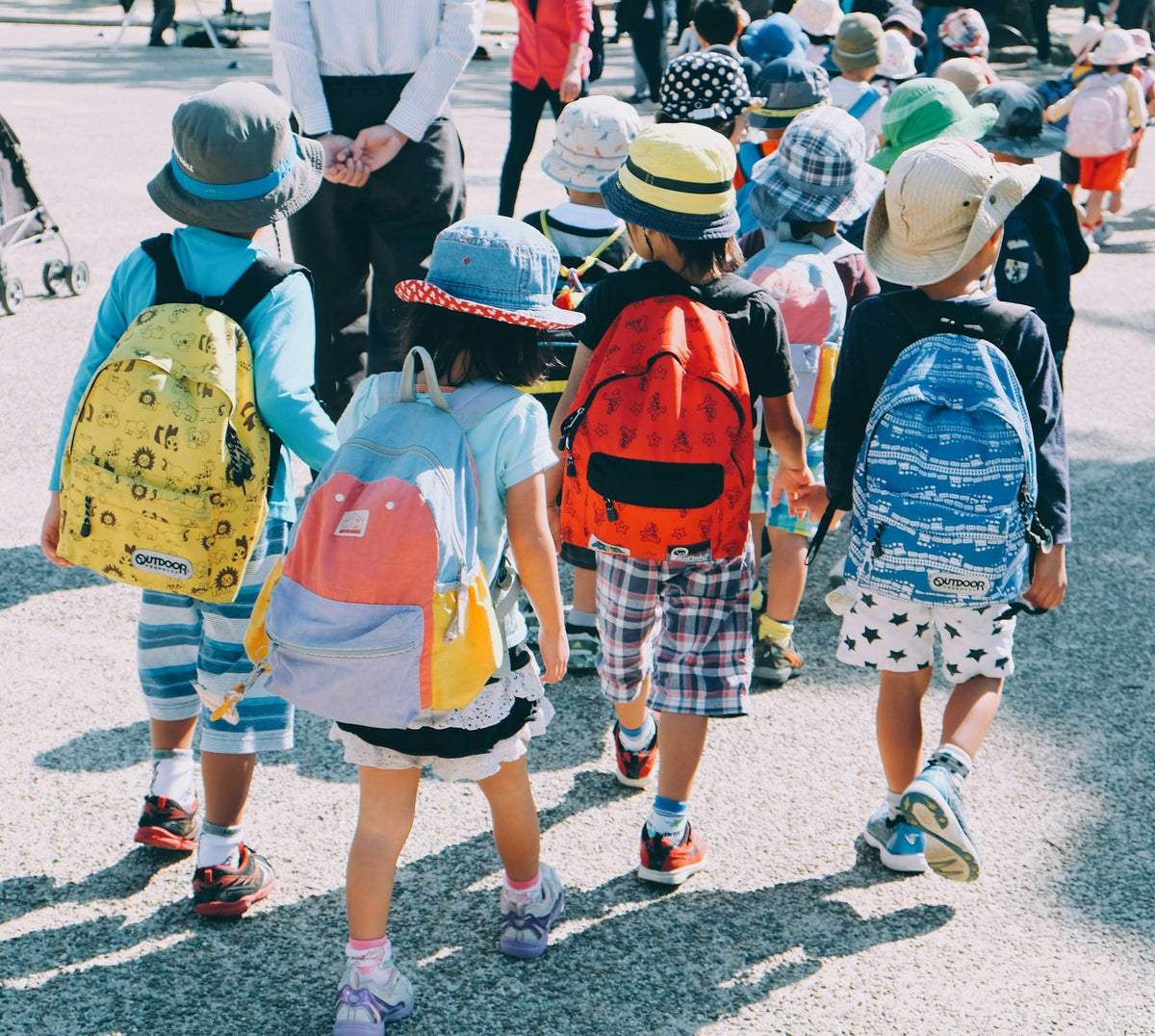 Group of people walking while wearing packs