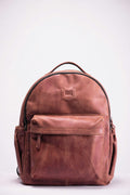 Brown leather backpack on a light surface